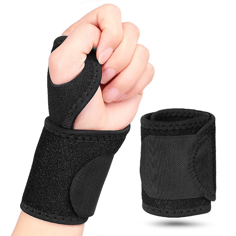 Black neoprene wrist support brace with a thumb loop and wide hook-and-loop closure strap, shown worn and unworn
